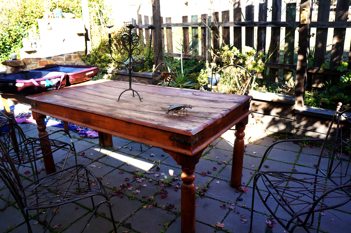 The back patio...or is it the front? Anyway, lovely patio set with great little decorative knick knacks every where.
