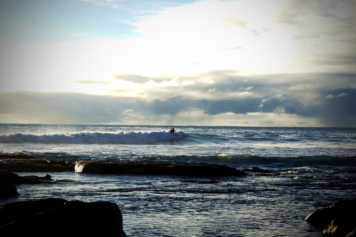 Lone sunset surfer