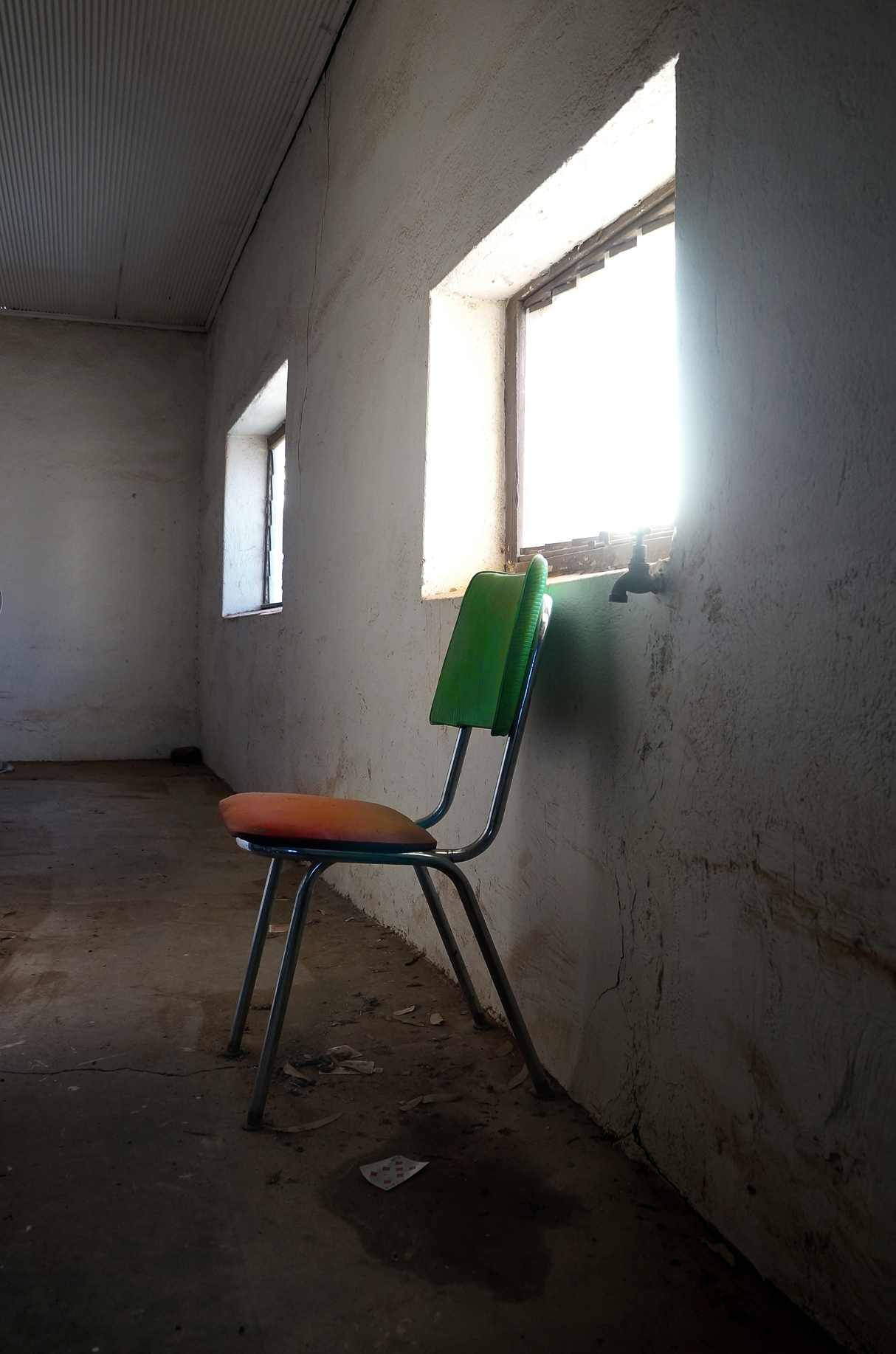 I really liked this chair in this room...the vibrant green and red against the starkness of the barren, whitewashed room